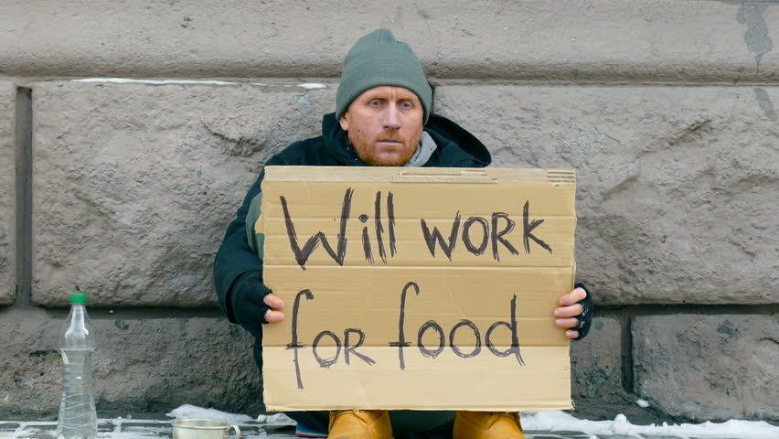 man with sign saying 'will work for food'